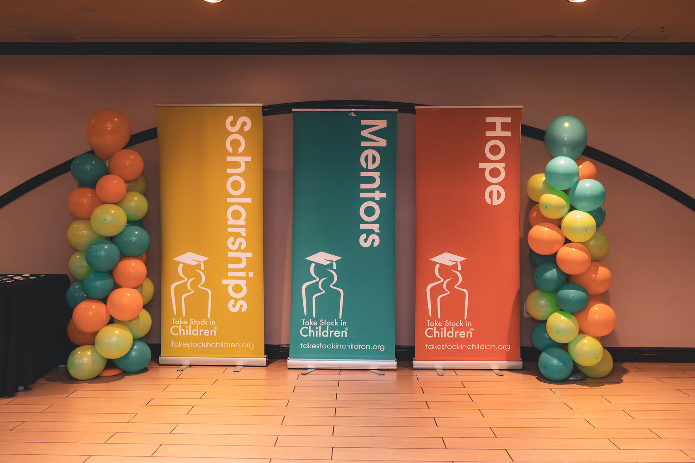 Scholarships, Mentors, and Hope banners at a Take Stock in Children of Broward event
