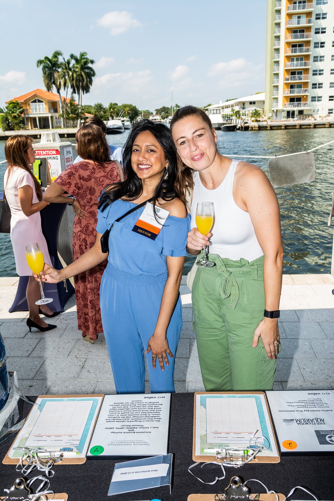 Two volunteers at a welcome table at a waterfront Take Stock event